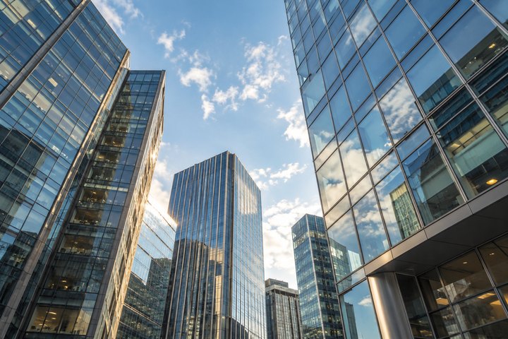 Looking up at glass skyscrapers