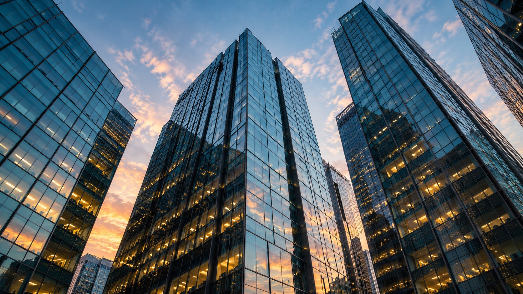Teal glass towers at sunset
